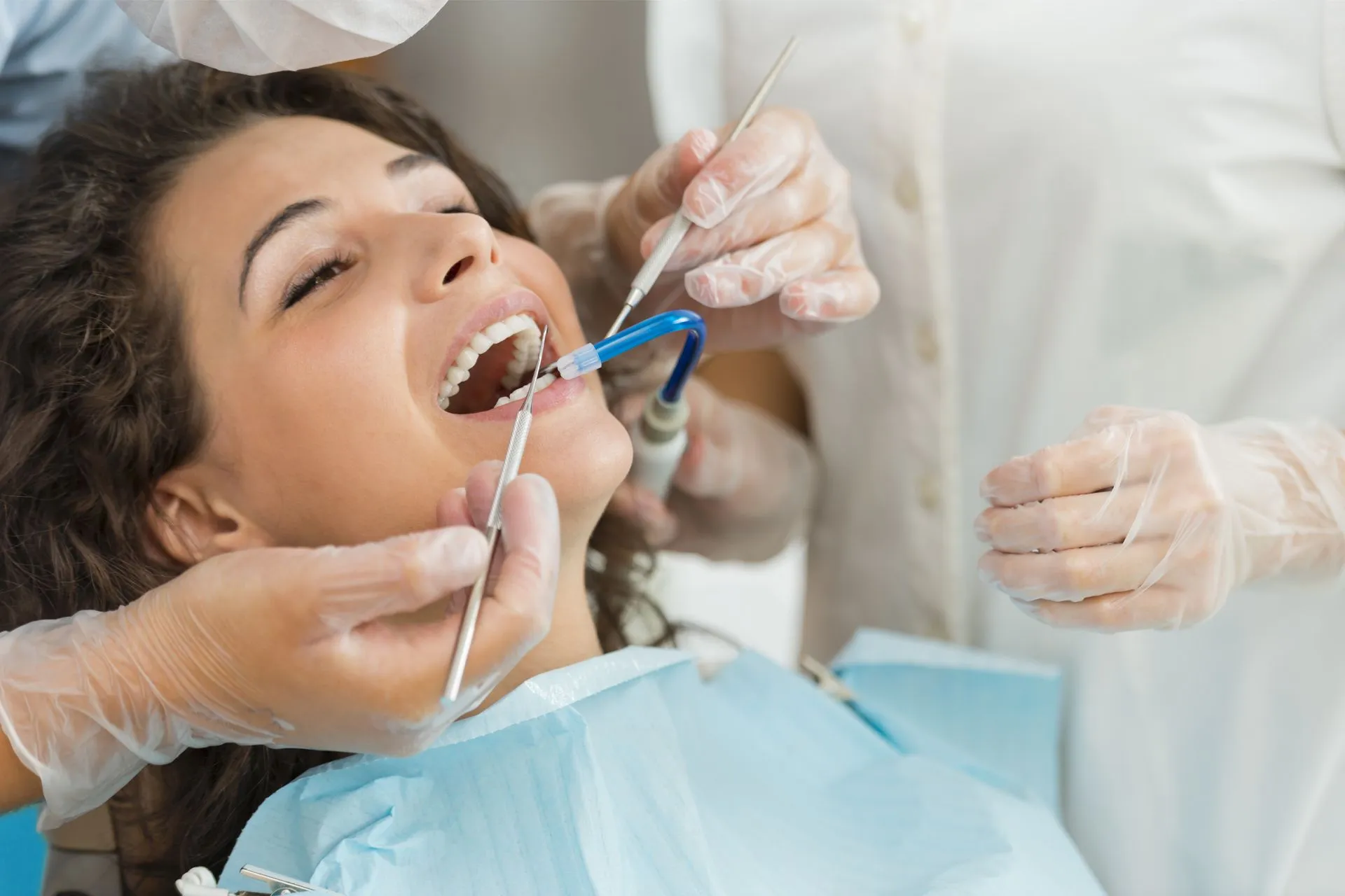 A hygienist treating a patient