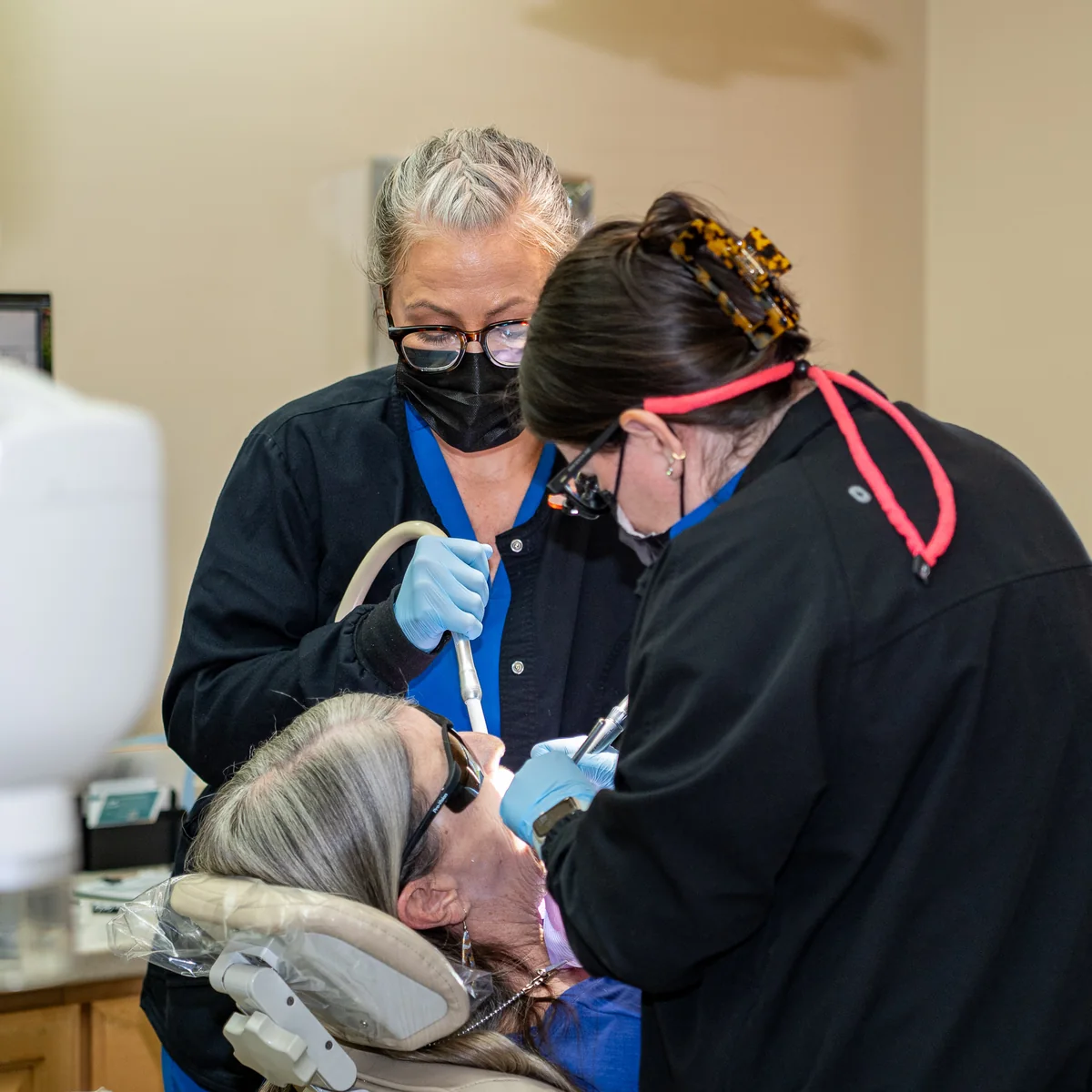 Two clinicians treating a patient at Sandstrom Dental in Mesa, Arizona