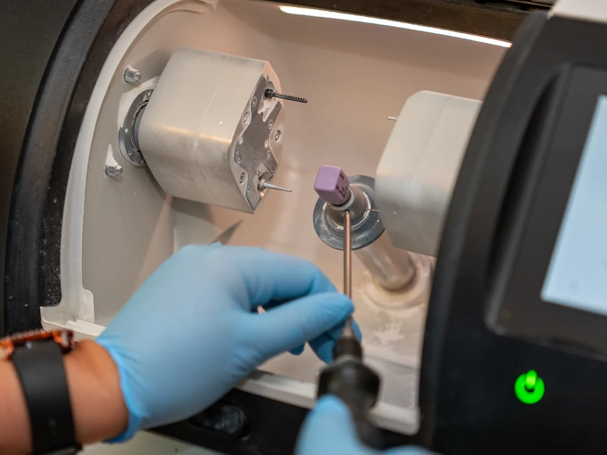 A ceramic block being loaded into the practice's crown milling unit